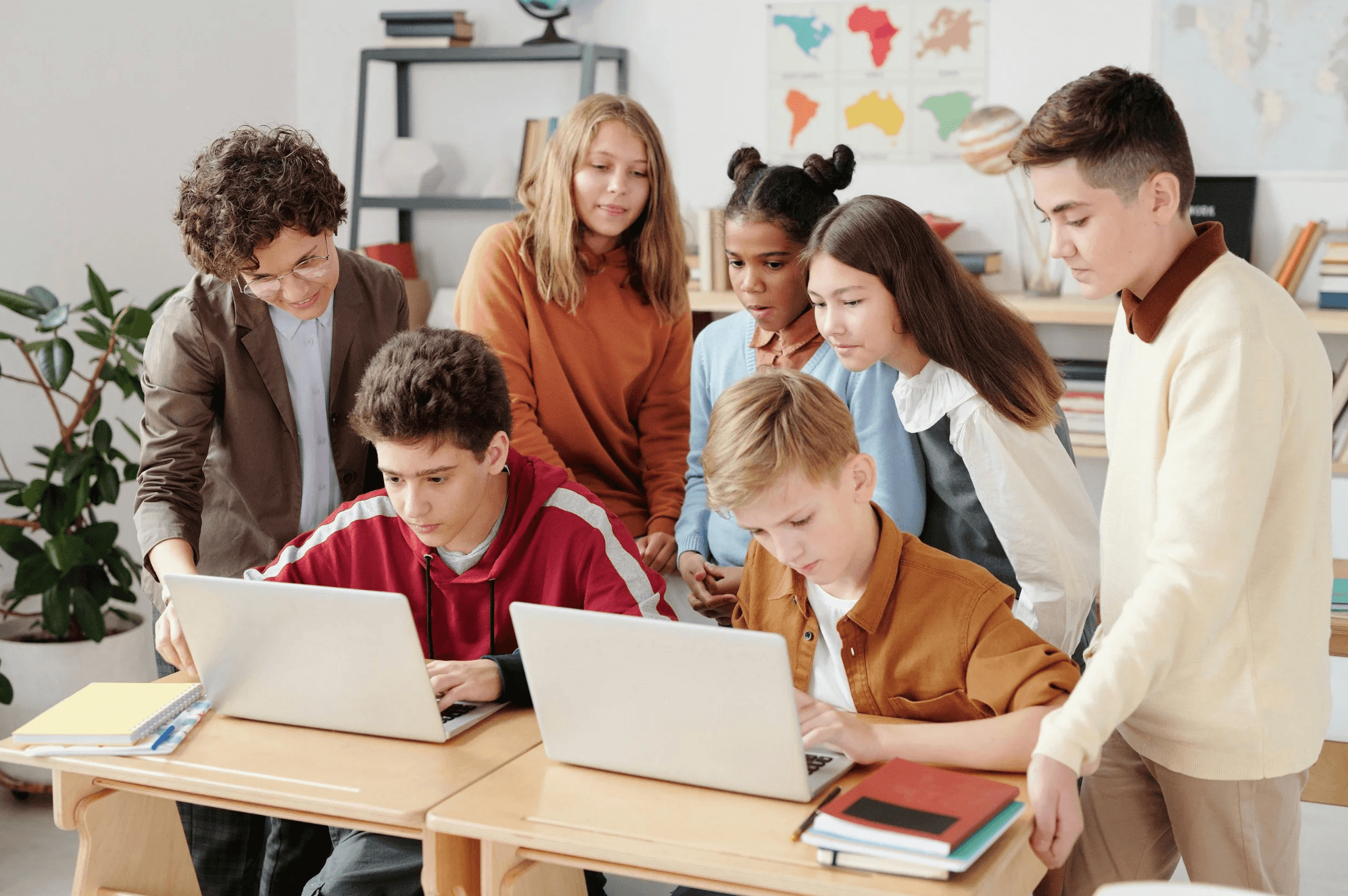 A class of students working together on laptops